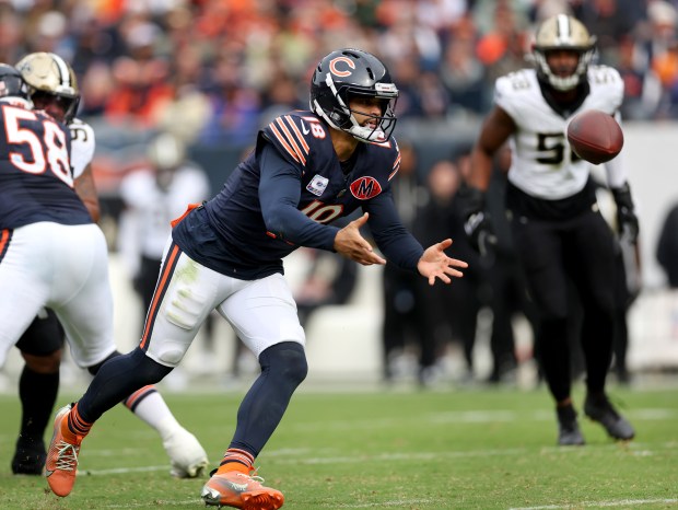 Chicago Bears quarterback Caleb Williams (18) pitches the ball to a running back in the third quarter of a game against the New Orleans Saints at Soldier Field in Chicago on Oct. 19, 2025. (Chris Sweda/Chicago Tribune)