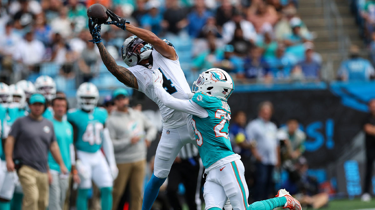 Carolina Panthers wide receiver Tetairoa McMillan (4) reaches for a pass with Miami Dolphins cornerback Jack Jones (23) defending during the third quarter at Bank of America Stadium.