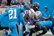 Dallas Cowboys running back Javonte Williams (33) is tackled by Carolina Panthers defense...