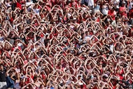 Oklahoma fans cheer for their team during the first half of an NCAA college football game...