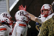 Rockwall-Heath's Carter Zahn (23), left, celebrates with his teammates after scoring a...