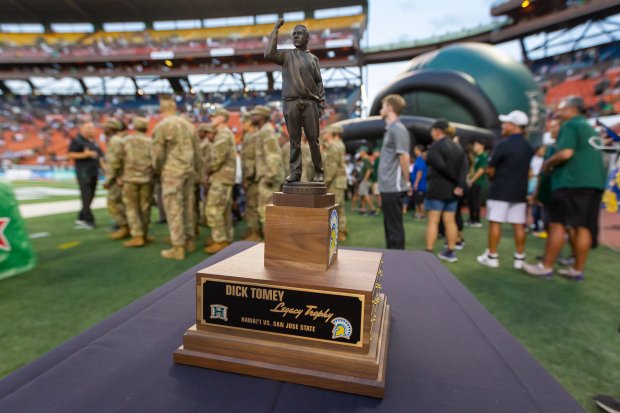 The Dick Tomey Legacy Trophy is on display before the start of an NCAA college football game between Hawaii and San Jose State, Saturday, Nov. 9, 2019, in Honolulu. (AP Photo/Eugene Tanner)
