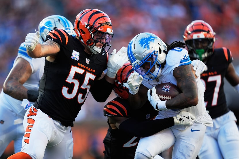 Detroit Lions running back Jahmyr Gibbs (0) runs through Cincinnati Bengals linebacker Logan...