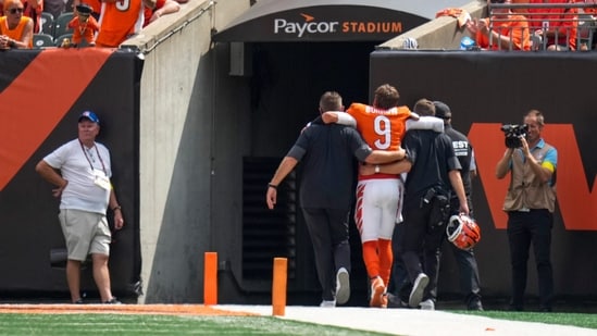 Cincinnati Bengals quarterback Joe Burrow (9) is assisted to the locker room with an injury in the second quarter at Paycor Stadium.(IMAGN IMAGES via Reuters Connect)