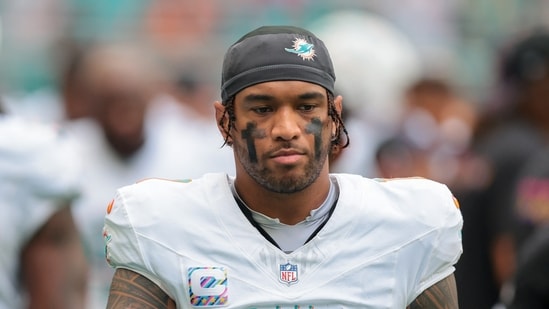 Miami Dolphins quarterback Tua Tagovailoa (1) walks by the bench area.(IMAGN IMAGES via Reuters Connect)