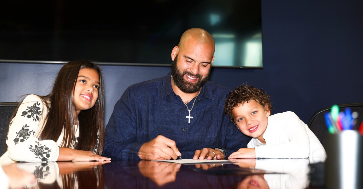 Lawrence Guy signs ceremonial contract to retire a Patriot