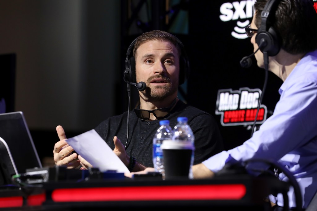 Former NFL player, Chris Long and SiriusXM host Adam Schein speak onstage during day 2 of SiriusXM at Super Bowl LIV on January 30, 2020 in Miami, Florida. 