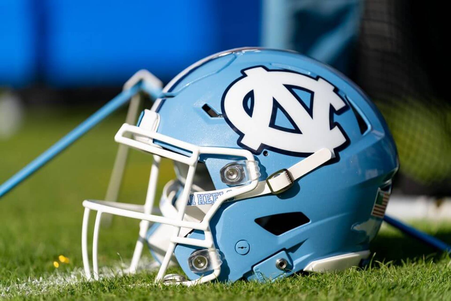 A North Carolina helmet sits on the sideline during a college football game.