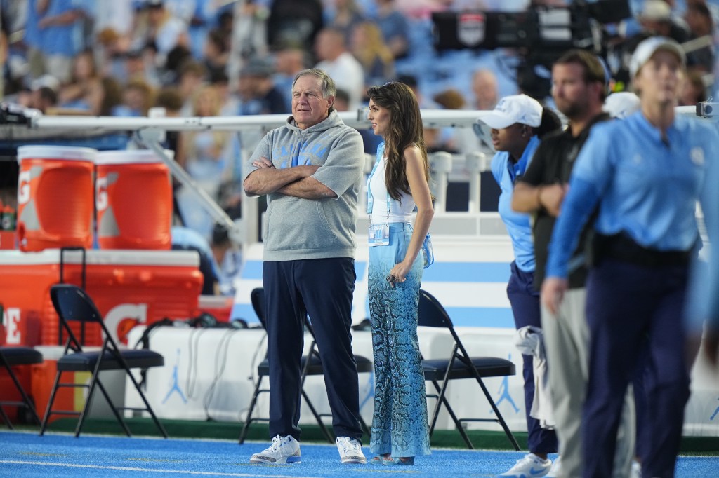 North Carolina head coach Bill Belichick and girlfriend Jordon Hudson look on from the sideline vs TCU at Kenan Memorial Stadium.