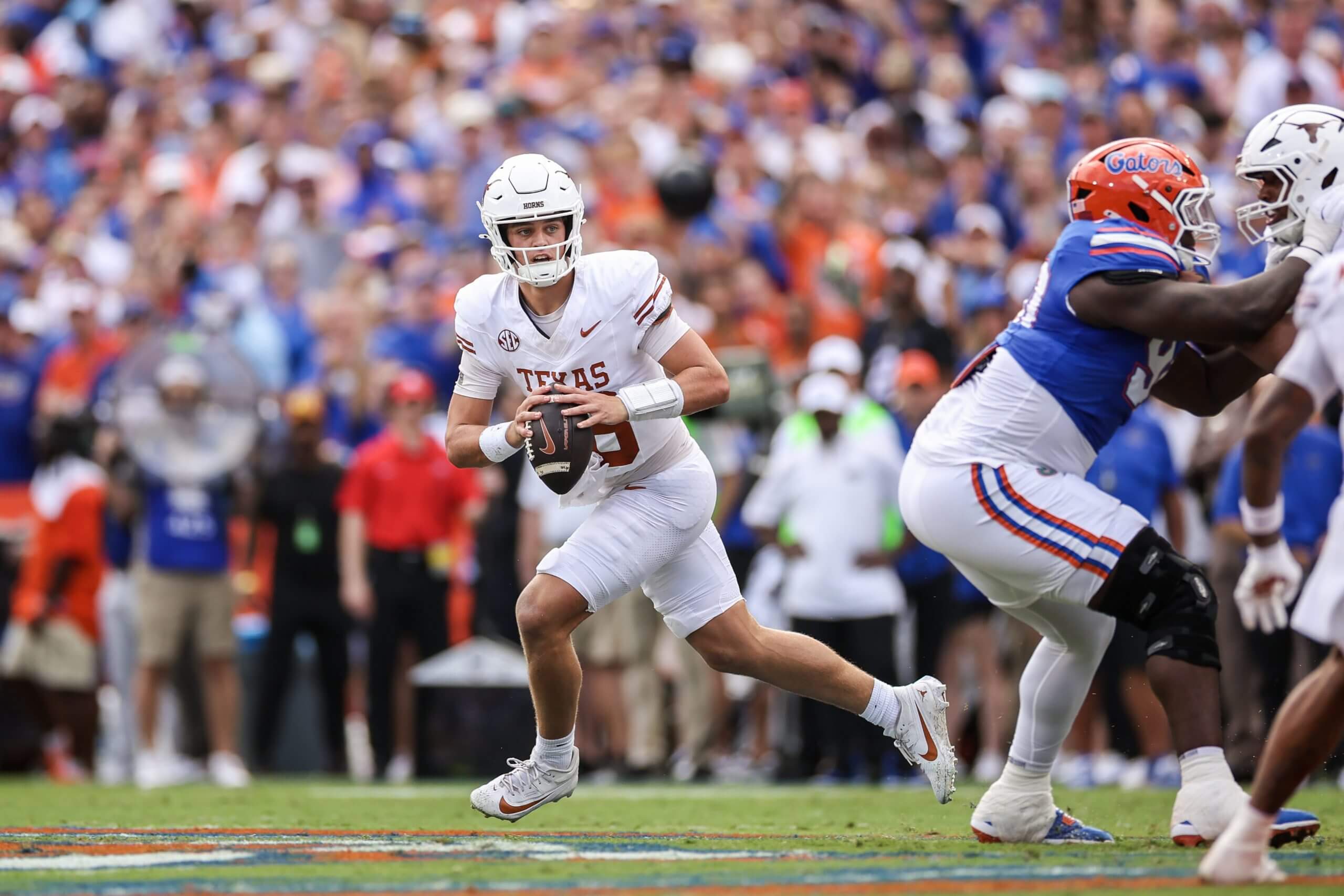 Arch Manning rolling out to throw a pass during Texas' 29-21 loss to Florida last Saturday