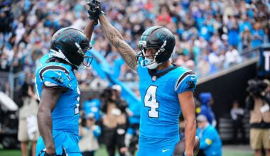 Carolina Panthers receiver Tetairoa McMillan (4) clasped hands with teammate Xavier Legette after McMillan caught his first career touchdown pass in the first half against the Dallas Cowboys in Charlotte, N.C.