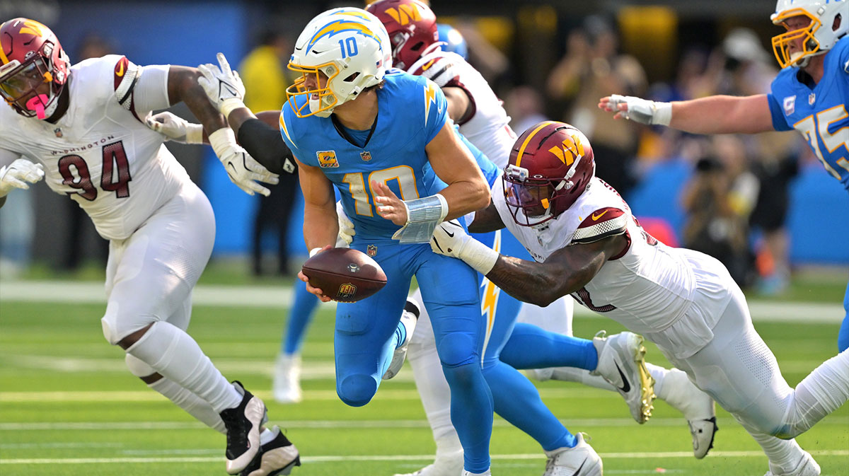 Washington Commanders defensive end Dorance Armstrong (92) sacks Los Angeles Chargers quarterback Justin Herbert (10) in the second half at SoFi Stadium.