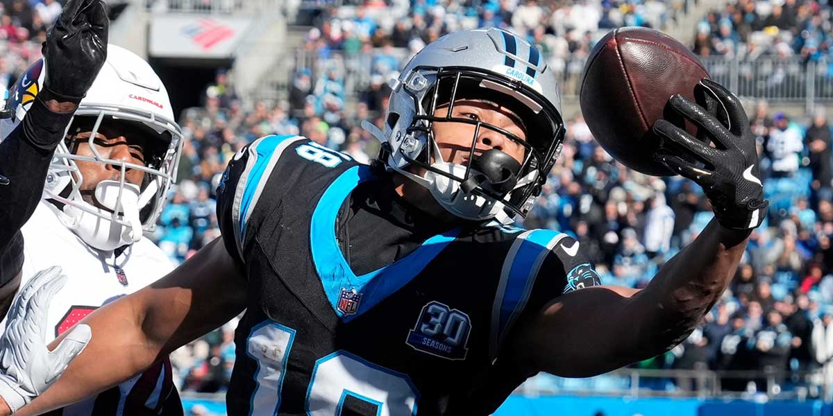 Carolina Panthers wide receiver Jalen Coker (18) attempts to catch the ball in the end zone as Arizona Cardinals safety Jalen Thompson (34) defends in the first quarter at Bank of America Stadium