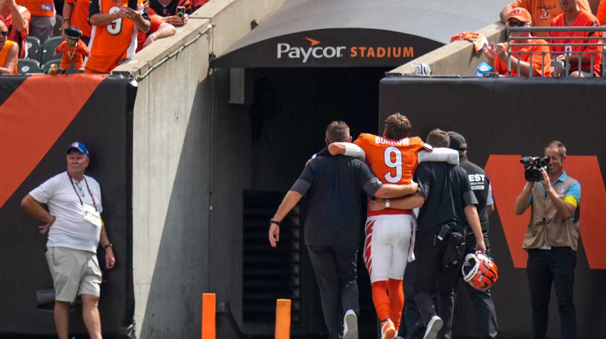 Cincinnati Bengals quarterback Joe Burrow (9) is assisted to the locker room with an injury in the second quarter of the NFL Week 2 game between the Cincinnati Bengals and the Jacksonville Jaguars at Paycor Stadium in downtown Cincinnati
