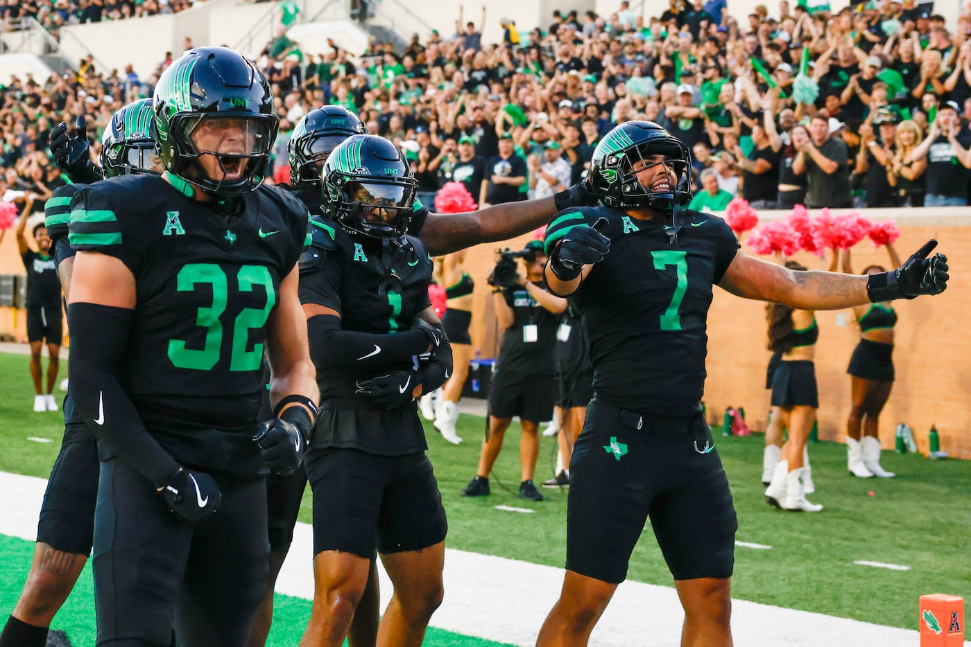 The North Texas defense celebrates after recovering a fumble during the first half of an...