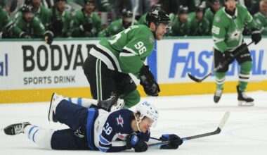 Winnipeg Jets center Morgan Barron (36) falls to the ice competing against Dallas Stars' Mikko Rantanen (96) in the first period of Game 3 of a second-round NHL hockey playoff series in Dallas, Sunday, May 11, 2025. (AP Photo/Julio Cortez)
