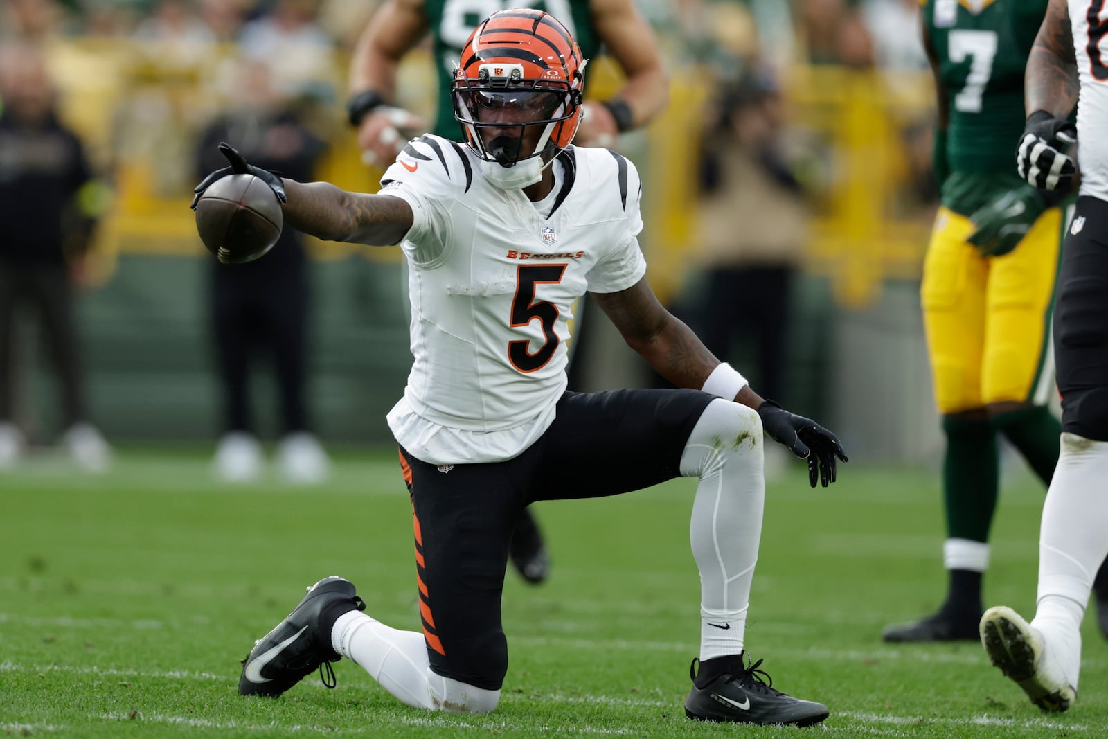 Cincinnati Bengals wide receiver Tee Higgins (5) celebrates a first down against the Green Bay Packers in the second half of an NFL football game, Sunday, Oct. 12, 2025, in Green Bay, Wis. (AP Photo/Matt Ludtke)