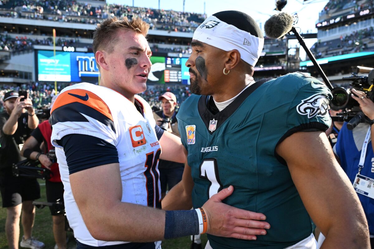 Denver Broncos quarterback Bo Nix (10) and Philadelphia Eagles quarterback Jalen Hurts (1) meet after the game at Lincoln Financial Field.