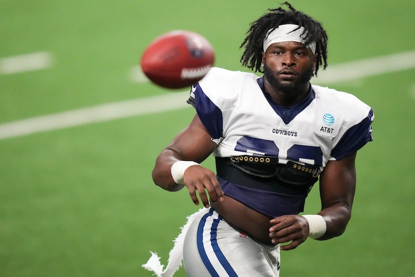 Dallas Cowboys running back Javonte Williams catches a ball during a practice at The Star on...