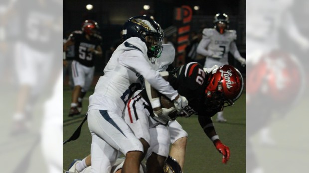 Calvary Chapel's Daniel Nieves brings down Westminster running back Alim Hopwood in the second quarter of the Eagles' 27-14 victory Friday, Sept. 5, 2025. (Photo by Steve Dulas)