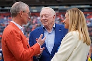 Dallas Cowboys owner and general manager Jerry Jones talks with Greg and Carrie Penner,...