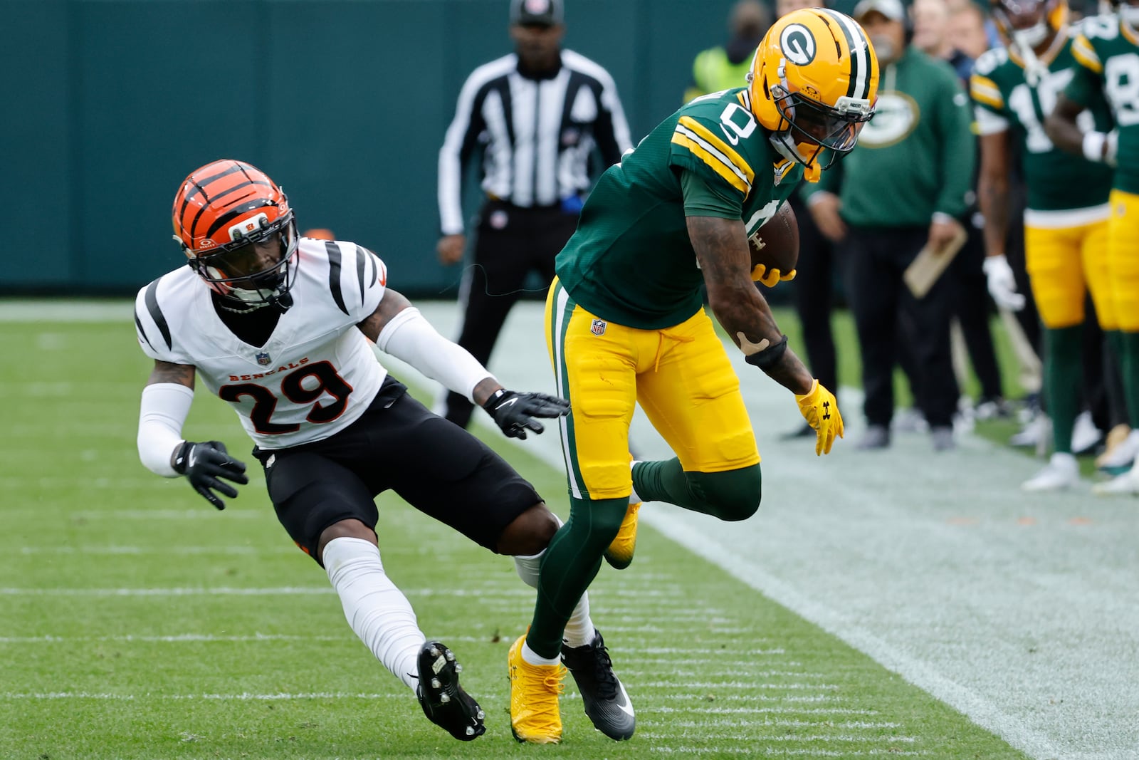 Green Bay Packers' Matthew Golden (0) runs after a catch aqgainst Cincinnati Bengals cornerback Josh Newton (28) in the first half of an NFL football game, Sunday, Oct. 12, 2025, in Green Bay, Wis. (AP Photo/Mike Roemer)