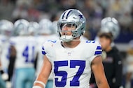 Dallas Cowboys linebacker Jack Sanborn stands on the field during an NFL football game...