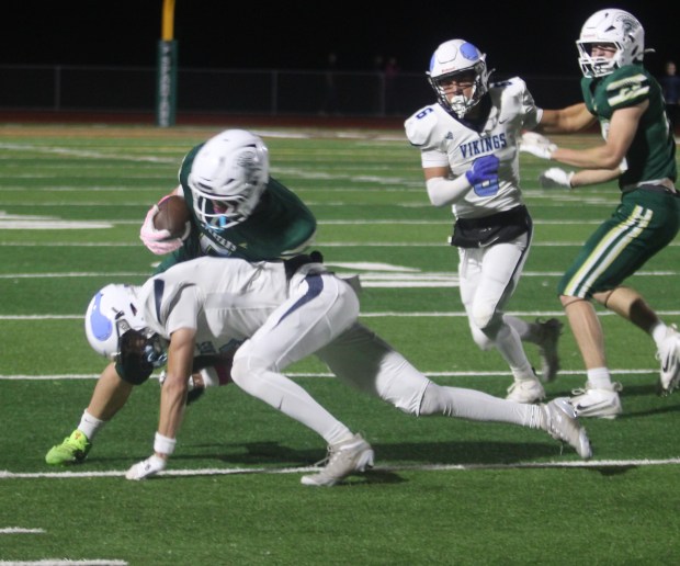 Pleasant Valley's Brody Moore tackles Red Bluff's AJ Eden after...