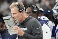 Dallas Cowboys defensive coordinator Matt Eberflus calls in a play during the first half of...