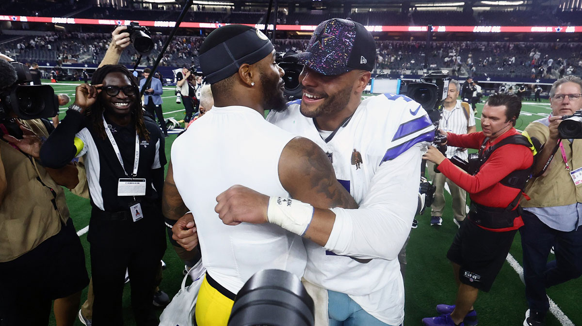 Dallas Cowboys quarterback Dak Prescott (4) and Green Bay Packers defensive end Micah Parsons (1) embrace after the game at AT&T Stadium.