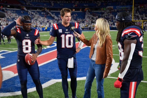 New England Patriots wide receiver Stefon Diggs (8), quarterback Drake Maye (10) and running back Rhamondre Stevenson are interviewed by NBC Sports sideline reporter Melissa Stark after an NFL game against the Buffalo Bills. (AP Photo/Adrian Kraus)