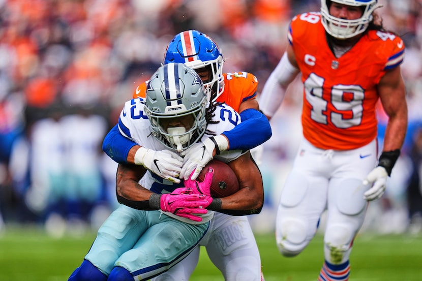 Dallas Cowboys running back Jaydon Blue (23) runs the ball and is stopped by Denver Broncos...
