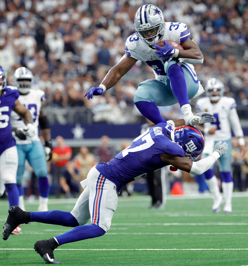 Dallas Cowboys running back Javonte Williams (33) leapt and stepped off New York Giants...