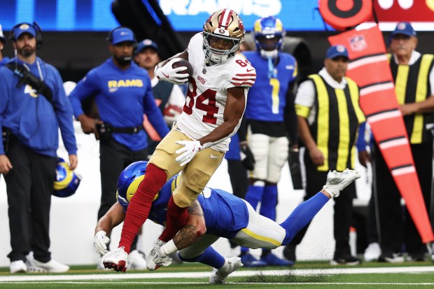 San Francisco 49ers wide receiver Kendrick Bourne (84) runs in front of Los Angeles Rams linebacker Nate Landman during the first half of an NFL football game, Thursday, Oct. 2, 2025, in Inglewood, Calif. (AP Photo/Jessie Alcheh)