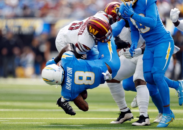 Omarion Hampton #8 of the Los Angeles Chargers is tackled during the first quarter against the Washington Commanders at SoFi Stadium on Oct. 05, 2025 in Inglewood, California. (Photo by Ronald Martinez/Getty Images)