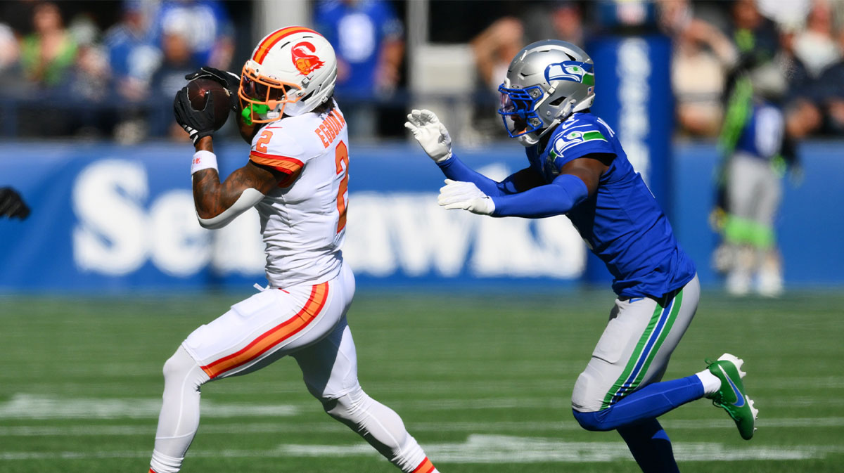 Tampa Bay Buccaneers wide receiver Emeka Egbuka (2) runs after the catch as Seattle Seahawks cornerback Derion Kendrick (1) defends during the first half at Lumen Field.