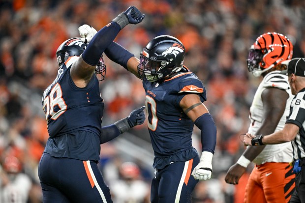 John Franklin-Myers (98) of the Denver Broncos his sack on Jake Browning (6) of the Cincinnati Bengals with teammate Jonathon Cooper (0) during the fourth quarter at Empower Field at Mile High on Monday, Sept. 29, 2025. (Photo by AAron Ontiveroz/The Denver Post)