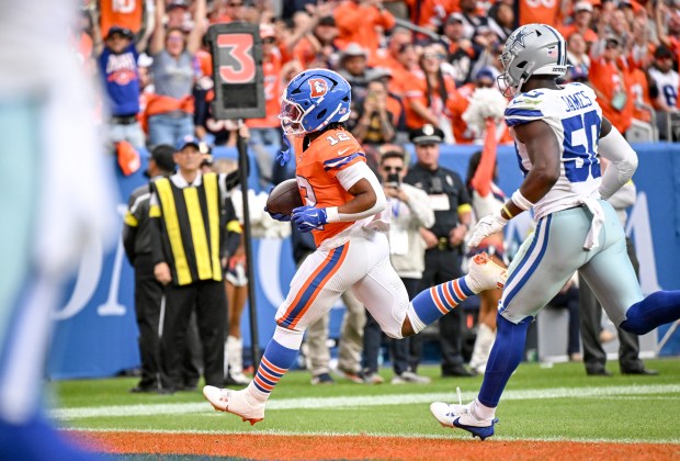 RJ Harvey (12) of the Denver Broncos scores a receiving touchdown as Shemar James (50) of the Dallas Cowboys trails during the fourth quarter of the Broncos 44-24 win at Empower Field at Mile High in Denver on Sunday, Oct. 26, 2025. (Photo by AAron Ontiveroz/The Denver Post)