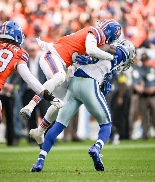 Kris Abrams-Draine (31) of the Denver Broncos tackles CeeDee Lamb (88) of the Dallas Cowboys during the fourth quarter at Empower Field at Mile High in Denver on Sunday, Oct. 26, 2025. (Photo by AAron Ontiveroz/The Denver Post)