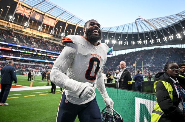 Jonathon Cooper (0) of the Denver Broncos smiles as he races to hug his mother, Jessica Moorman, after the fourth quarter of the Broncos' 13-11 win over the New York Jets at Tottenham Hotspur Stadium in London on Sunday, Oct. 12, 2025. (Photo by AAron Ontiveroz/The Denver Post)