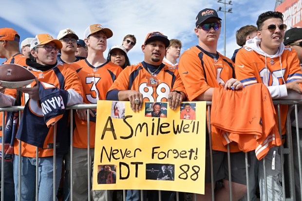 Lorenzo Jimenez, center, and Denver Broncos fans gather for the unveiling of Demaryius Thomas' pillar in the Ring of Fame Plaza at Empower Field at Mile High in Denver on Sunday, Oct. 19, 2025. (Photo by Hyoung Chang/The Denver Post)