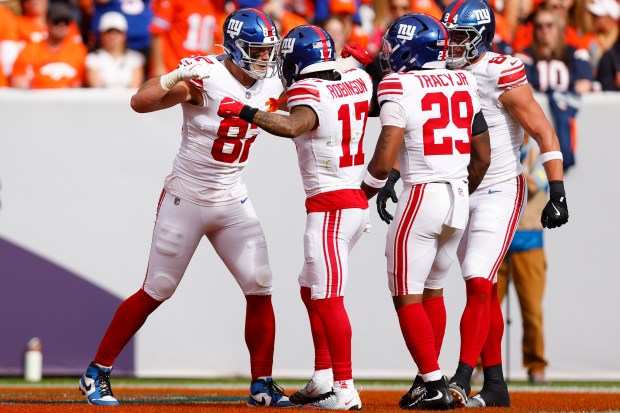 Daniel Bellinger #82 and Wan'Dale Robinson #17 of the New...