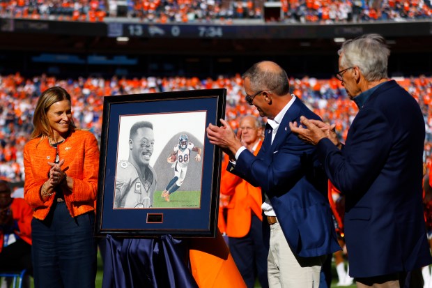Denver Broncos owners Carrie Walton Penner, Greg Penner, and Rob...