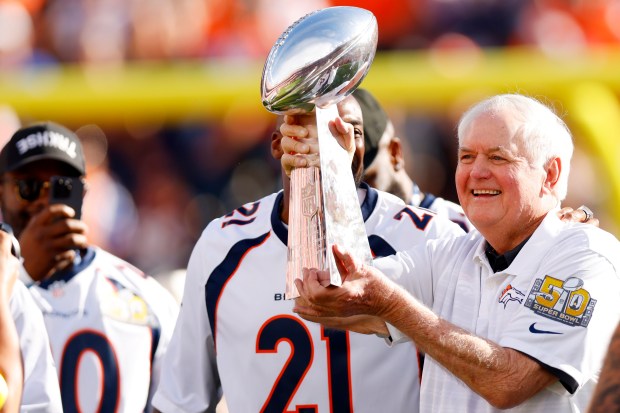Former Denver Broncos defensive coordinator Wade Phillips holds up the...