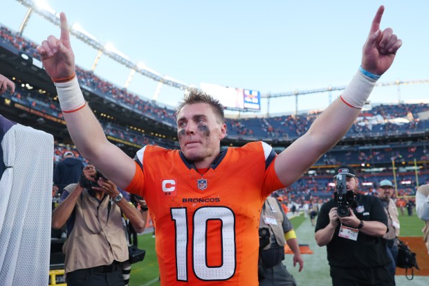 Bo Nix #10 of the Denver Broncos celebrates after his...