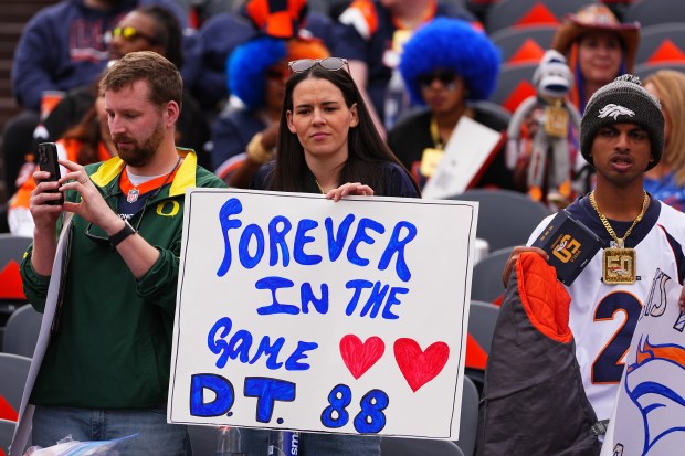 A fan holds up a sign for former Denver Broncos...