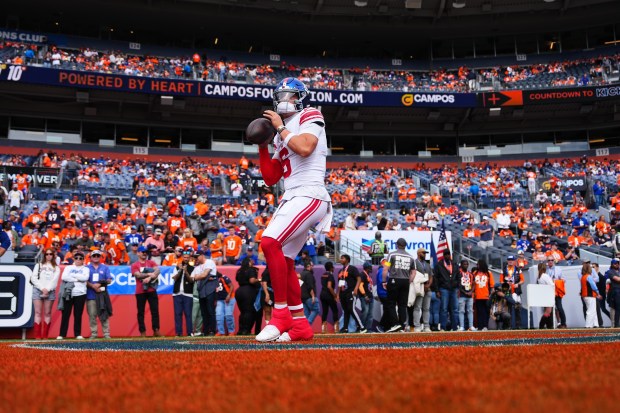 New York Giants quarterback Jaxson Dart (6) warms up before...