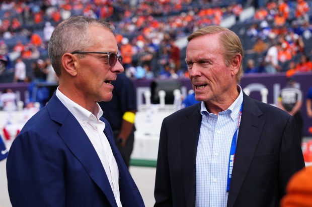 Denver Broncos owner and chief executive officer Greg Penner, left,...
