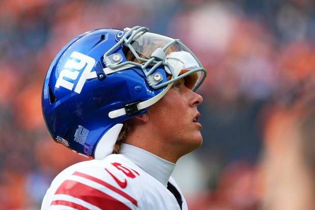 New York Giants quarterback Jaxson Dart warms up before an...