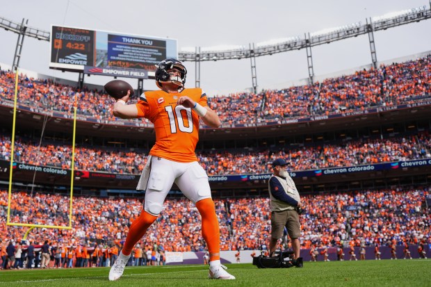 Denver Broncos quarterback Bo Nix (10) warms up before an...